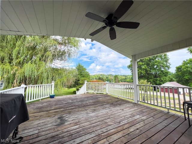 wooden deck with ceiling fan and a grill