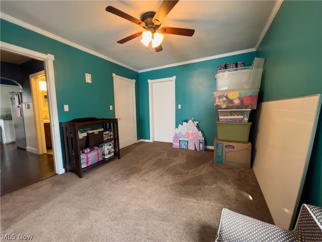 playroom with crown molding, carpet floors, and ceiling fan