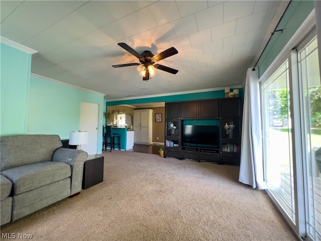 carpeted living room featuring ceiling fan and ornamental molding