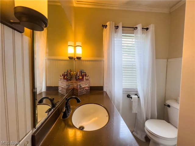 bathroom featuring vanity, toilet, and ornamental molding