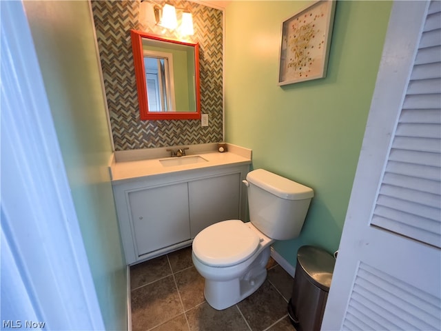 bathroom featuring tile patterned floors, vanity, and toilet