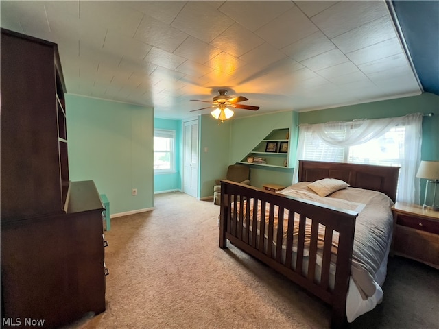 bedroom with ceiling fan and light carpet