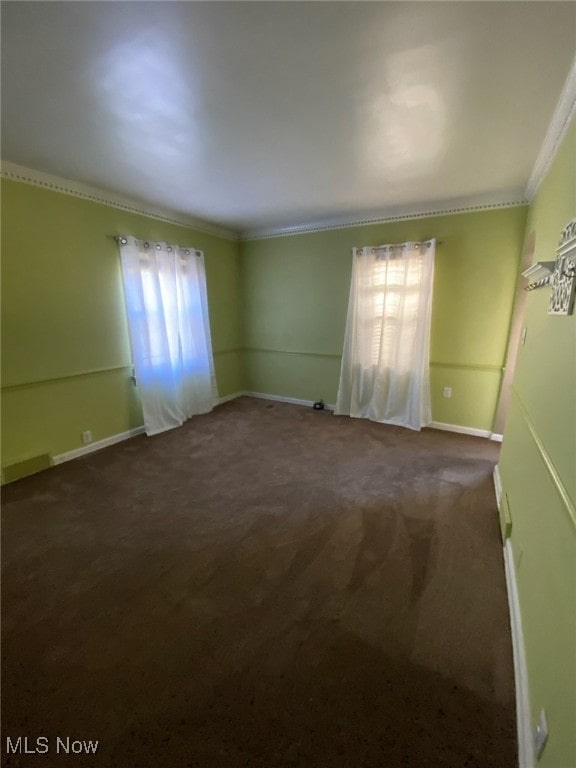 carpeted spare room with crown molding