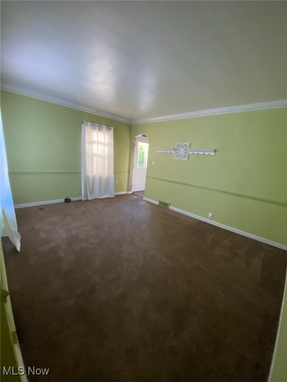 carpeted empty room featuring ornamental molding