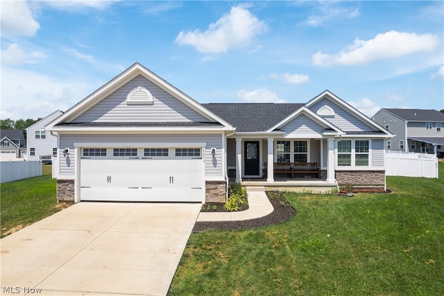 craftsman house with a garage, covered porch, and a front yard