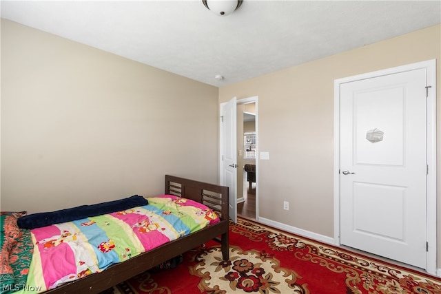 bedroom with hardwood / wood-style flooring