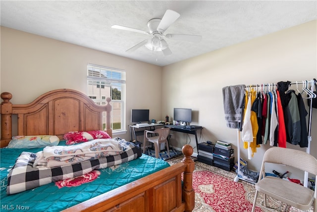 bedroom with a textured ceiling and ceiling fan