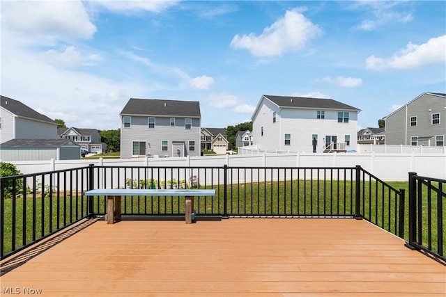 wooden deck with a lawn