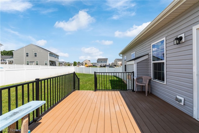 wooden terrace featuring a lawn