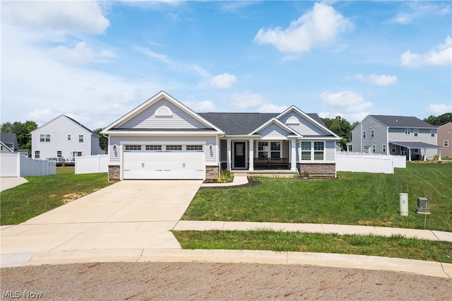 craftsman-style home featuring a garage and a front lawn