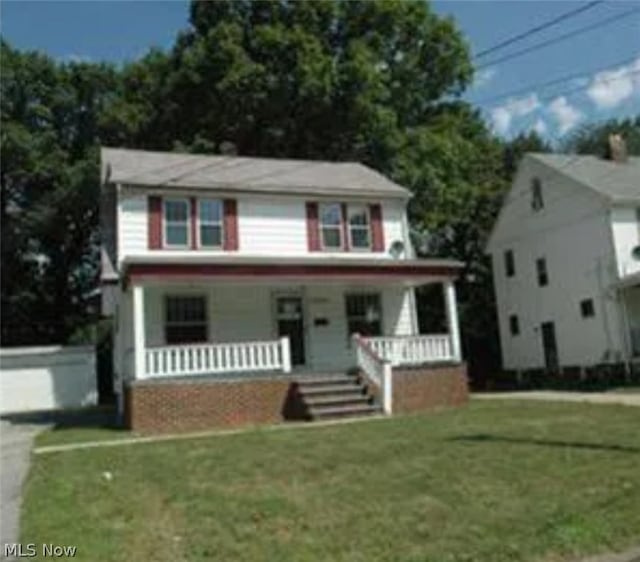 view of front of home featuring covered porch and a front yard