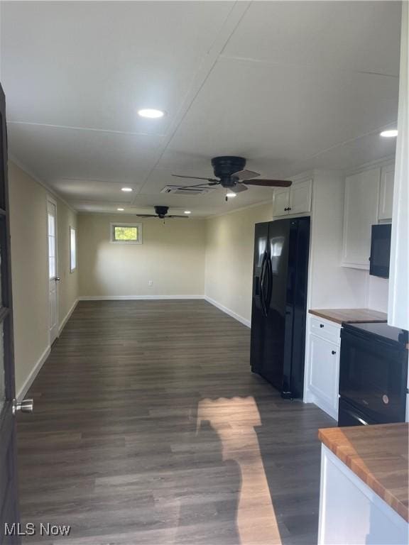 kitchen featuring wood counters, black appliances, and white cabinets