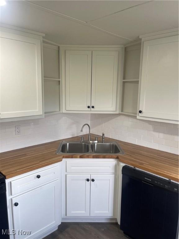 kitchen with butcher block countertops, sink, dishwasher, white cabinetry, and backsplash