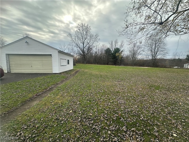 view of yard with a garage and an outdoor structure