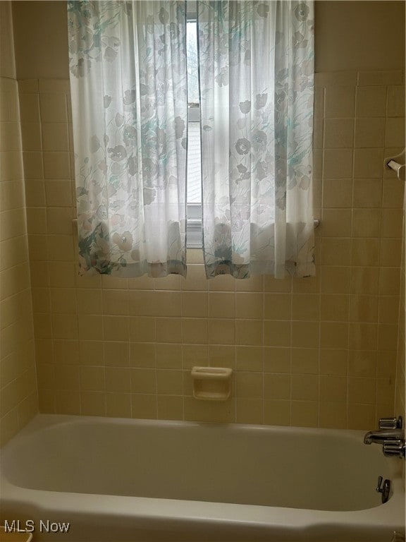 bathroom with shower / bath combination with curtain