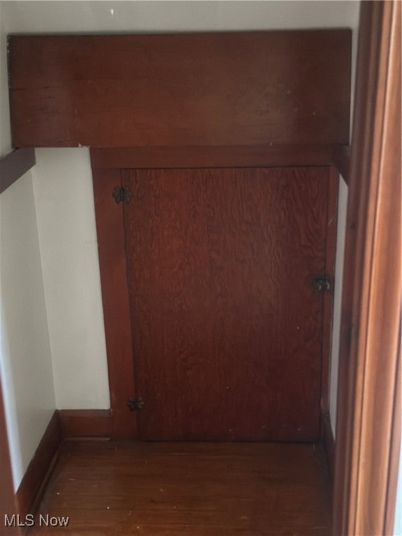 hallway featuring dark hardwood / wood-style flooring