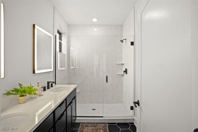 full bath with a shower stall, tile patterned floors, double vanity, and a sink