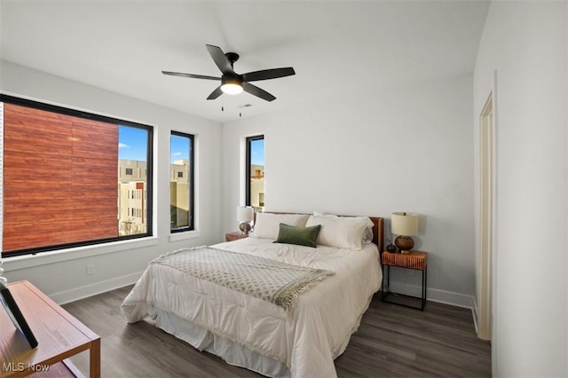 bedroom featuring wood finished floors, ceiling fan, and baseboards
