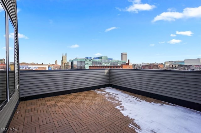 view of patio / terrace with a view of city and a balcony