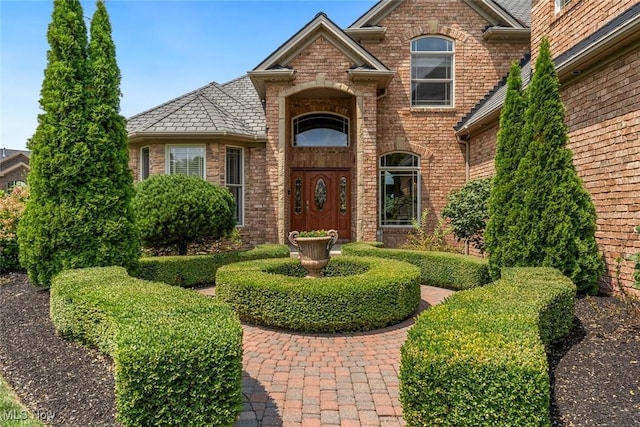 property entrance featuring brick siding