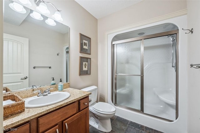 full bath featuring vanity, toilet, and a shower stall