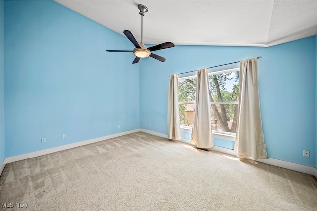 carpeted spare room featuring lofted ceiling and ceiling fan