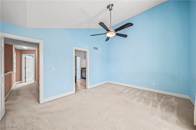 unfurnished bedroom featuring light colored carpet, high vaulted ceiling, and ceiling fan