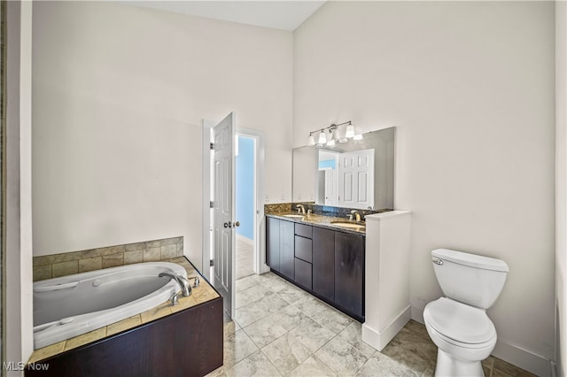 bathroom with tile patterned flooring, a high ceiling, double vanity, tiled bath, and toilet