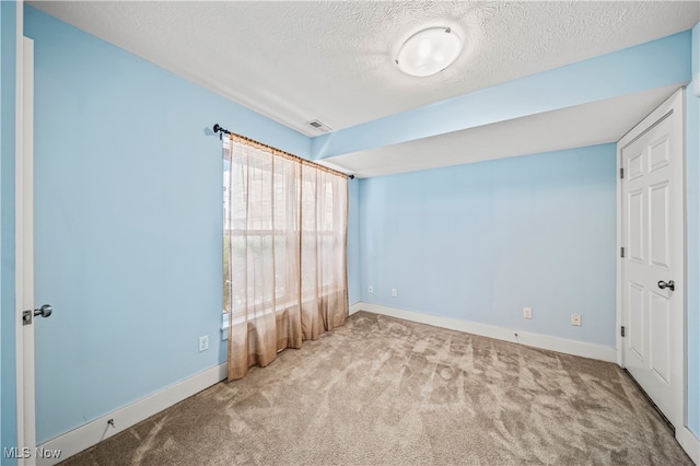 unfurnished bedroom with carpet floors and a textured ceiling