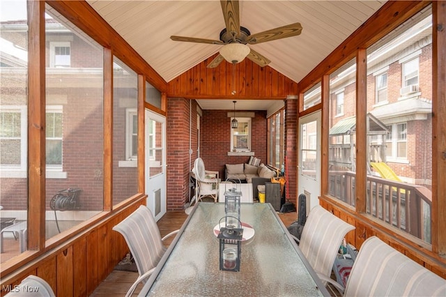 sunroom / solarium with lofted ceiling and ceiling fan