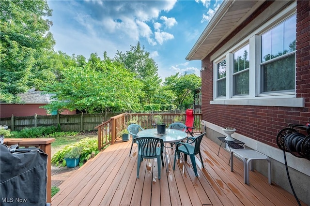 wooden deck with a grill