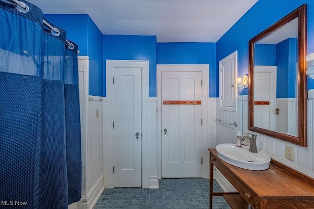 bathroom with sink, tile patterned floors, and curtained shower