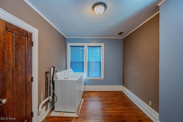 laundry room with washer and dryer, hardwood / wood-style flooring, and crown molding