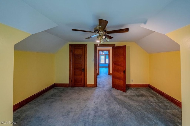 additional living space featuring vaulted ceiling, ceiling fan, and dark carpet