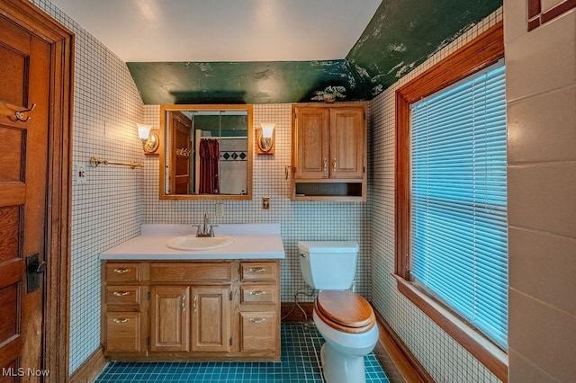 bathroom featuring toilet, vanity, and tile patterned floors