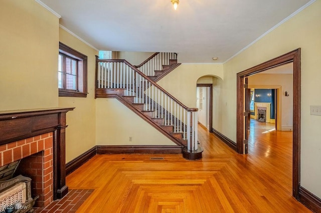 living room featuring crown molding and a fireplace