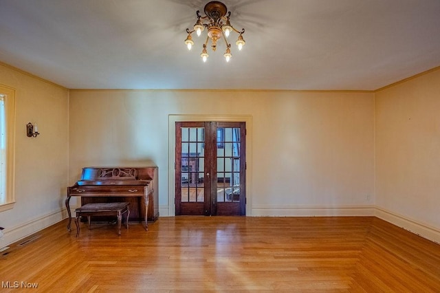 miscellaneous room featuring light parquet floors and french doors