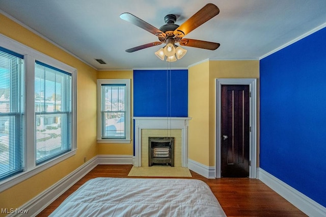 bedroom featuring ceiling fan, crown molding, and hardwood / wood-style flooring