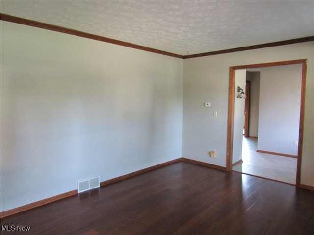 unfurnished room featuring crown molding, a textured ceiling, and dark hardwood / wood-style flooring