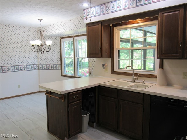 kitchen with sink, dark brown cabinets, kitchen peninsula, dishwasher, and pendant lighting