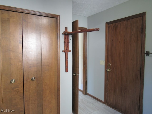 corridor featuring a textured ceiling