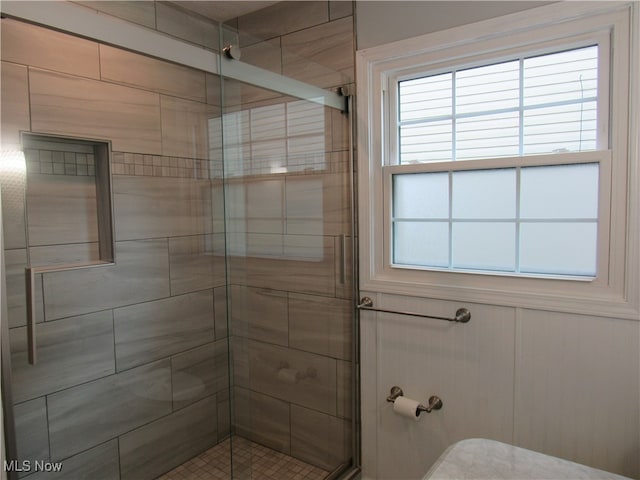 bathroom with an enclosed shower and toilet