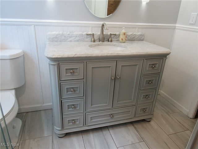 bathroom featuring vanity and toilet