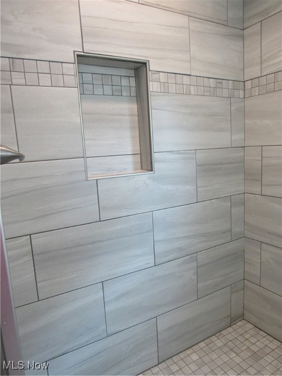 bathroom with a tile shower