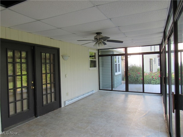 unfurnished sunroom featuring a paneled ceiling, french doors, ceiling fan, and baseboard heating