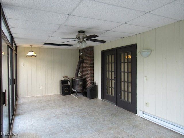 interior space featuring a baseboard heating unit, a patio area, ceiling fan, and french doors