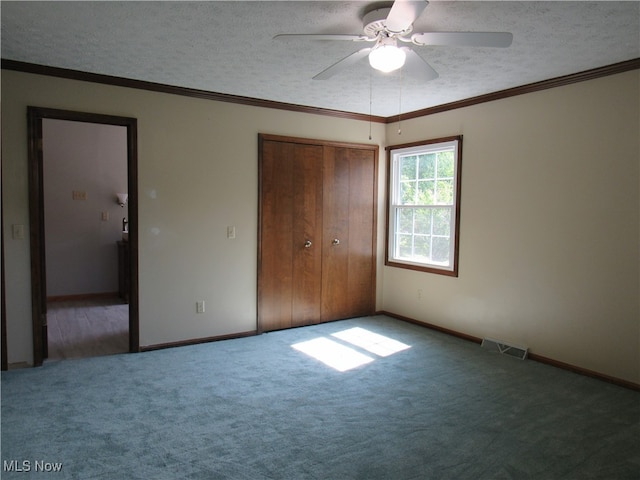 unfurnished bedroom with ceiling fan, carpet, a closet, and a textured ceiling