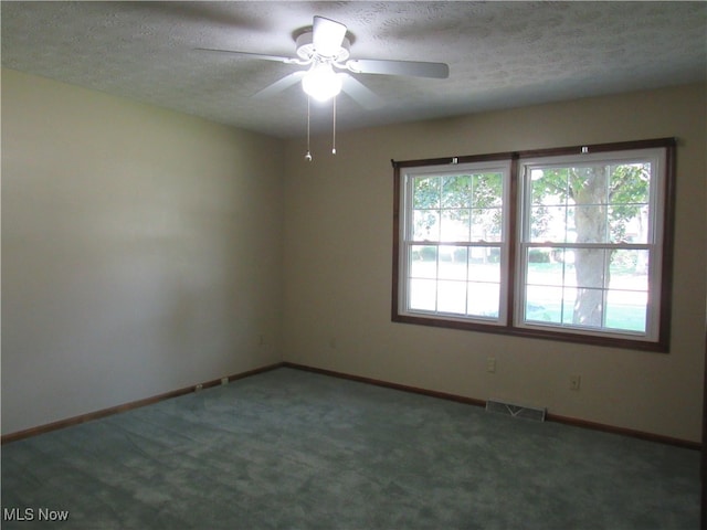 unfurnished room featuring ceiling fan, carpet flooring, and a textured ceiling