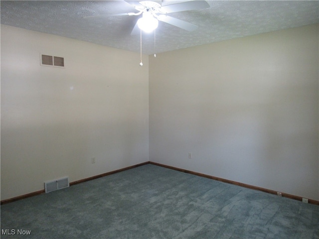 carpeted empty room with ceiling fan and a textured ceiling