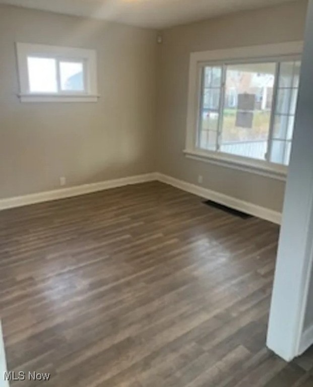 spare room featuring dark hardwood / wood-style flooring